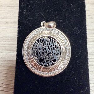 Elegant Silver Tone Pendant with Intricate Design